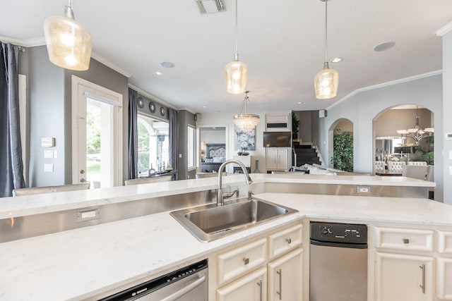kitchen featuring light stone counters, ornamental molding, a sink, visible vents, and open floor plan