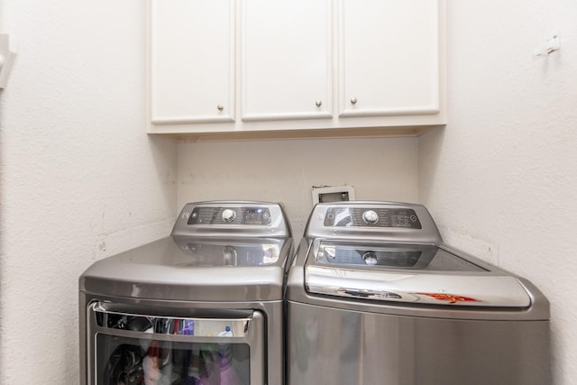 laundry area featuring cabinet space and washer and clothes dryer