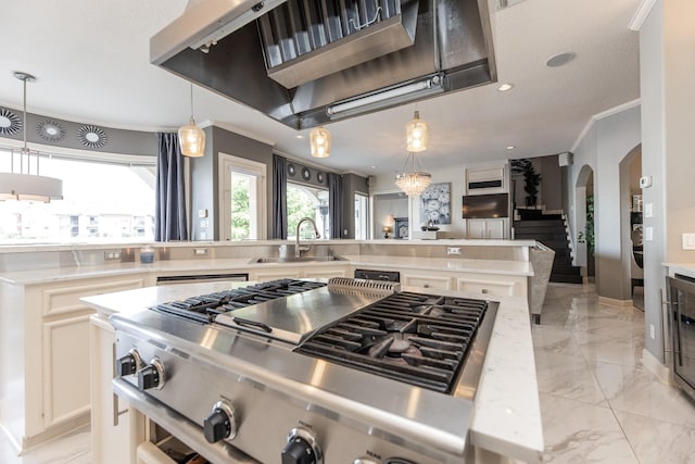 kitchen featuring arched walkways, stainless steel range, light countertops, ornamental molding, and a sink