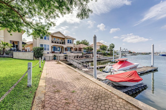 dock area featuring a lawn and a water view