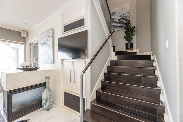 stairway featuring crown molding
