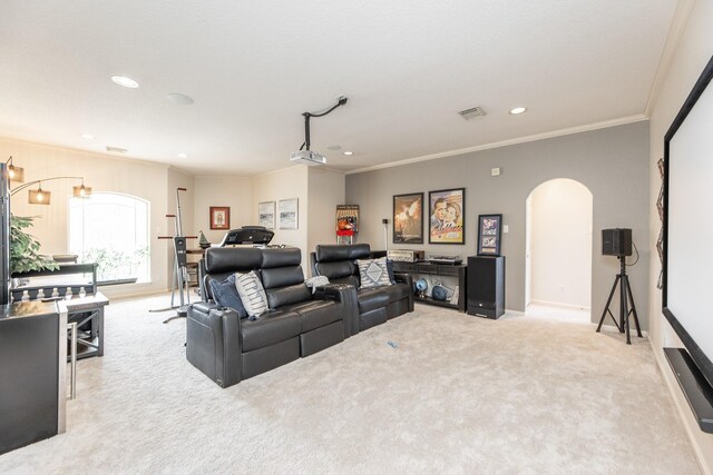 carpeted cinema room with recessed lighting, arched walkways, ornamental molding, baseboards, and visible vents