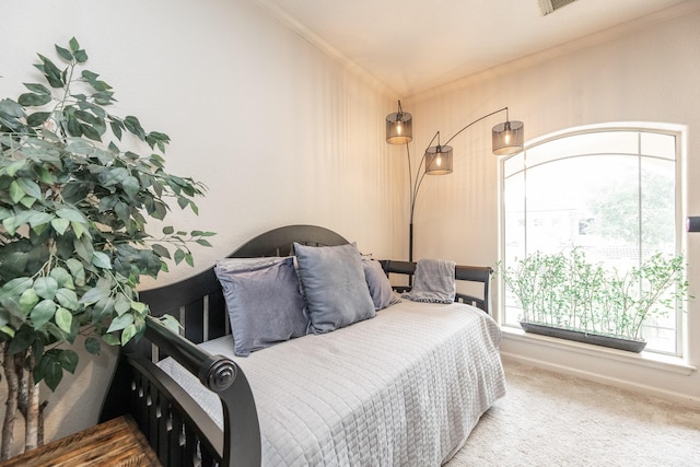carpeted bedroom with ornamental molding