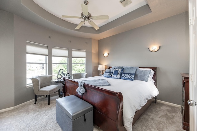 carpeted bedroom with visible vents, ceiling fan, and baseboards
