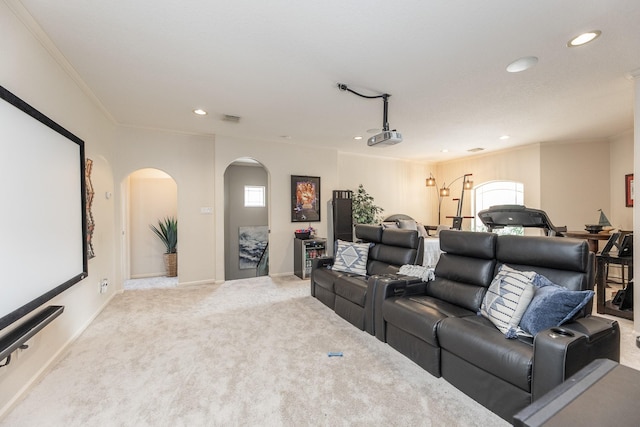 carpeted cinema room featuring recessed lighting, visible vents, baseboards, ornamental molding, and arched walkways