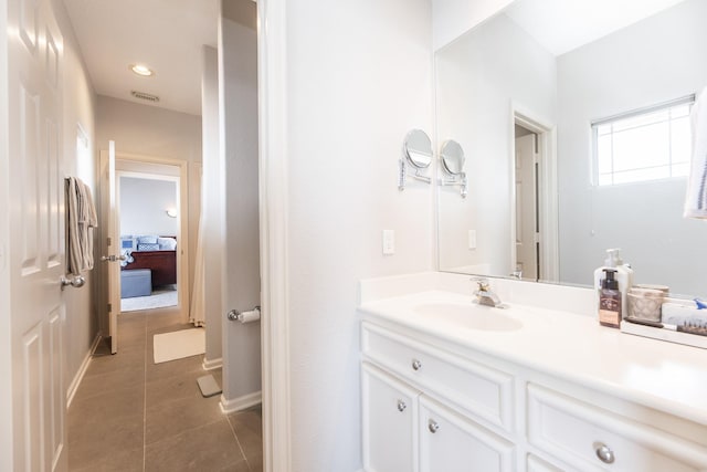 bathroom featuring tile patterned floors, visible vents, vanity, and ensuite bath