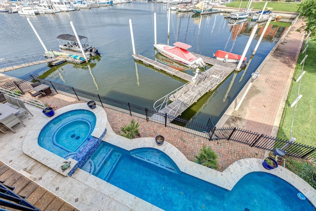 view of swimming pool featuring a dock, an in ground hot tub, and a water view