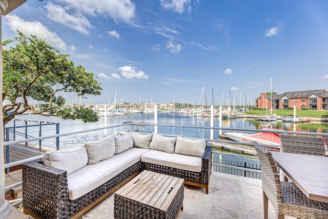 view of patio with an outdoor living space and a water view