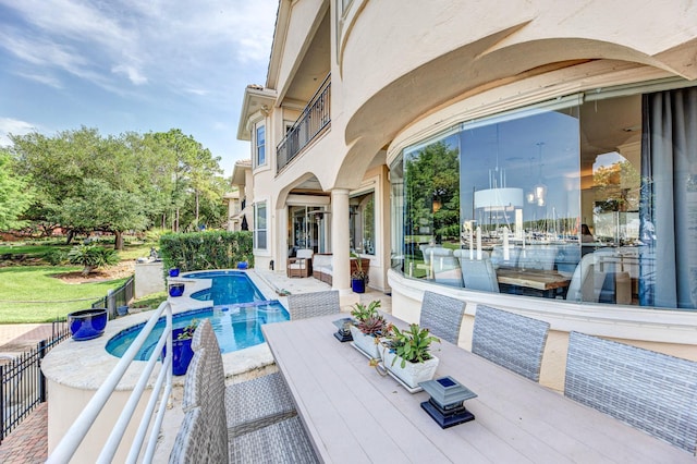 view of swimming pool with a pool with connected hot tub