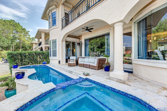 view of pool featuring a ceiling fan, a pool with connected hot tub, and a patio area