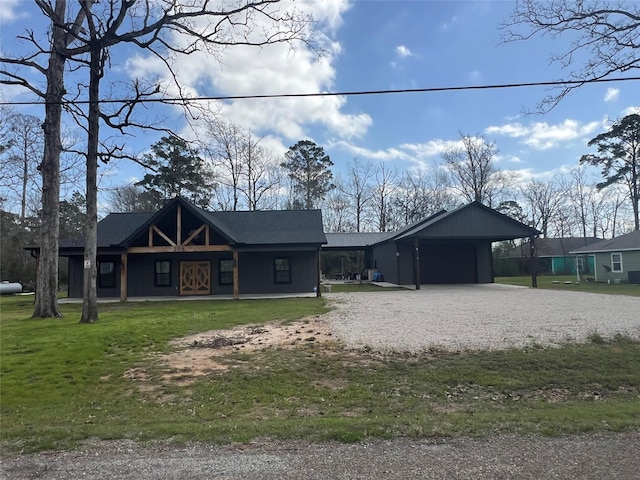 218 Strawberry St, Onalaska, TX 77360 - view of front of home with a porch, a front yard, gravel driveway, and a carport