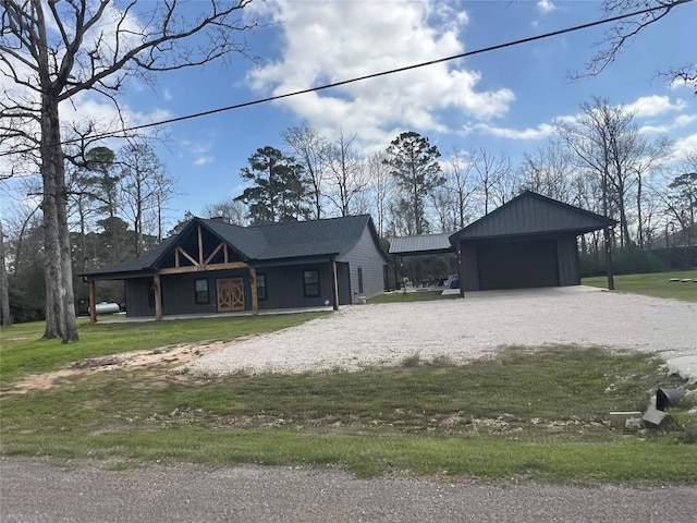 218 Strawberry St, Onalaska, TX 77360 - view of front of house featuring a detached garage, a front yard, and gravel driveway