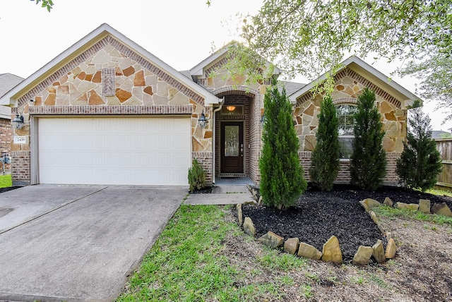 french country home featuring driveway, stone siding, brick siding, and a garage