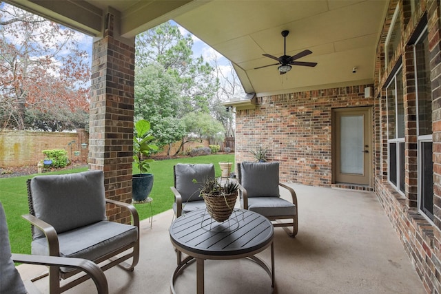 view of patio featuring fence and ceiling fan
