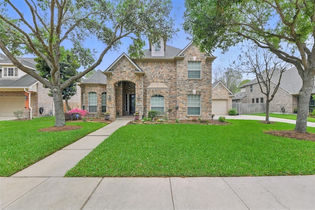 view of front of house with a front yard, a garage, stone siding, brick siding, and concrete driveway