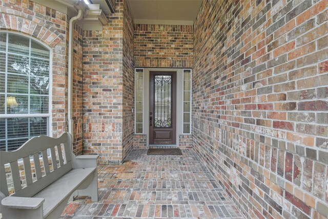 property entrance featuring brick siding