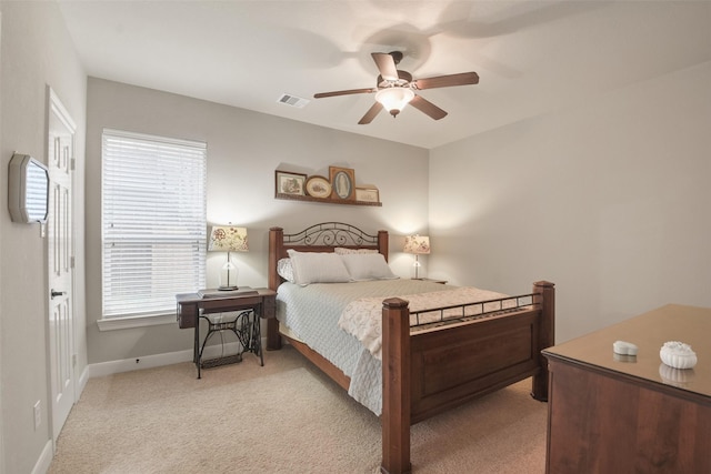 bedroom with baseboards, visible vents, a ceiling fan, and light colored carpet