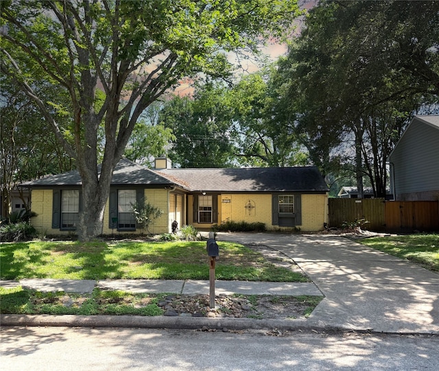 2319 Colleen Dr, Pearland, TX 77581 - view of front of house featuring driveway, brick siding, and a chimney