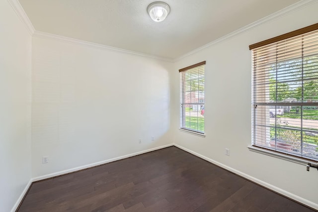 unfurnished room with crown molding, dark wood finished floors, and baseboards