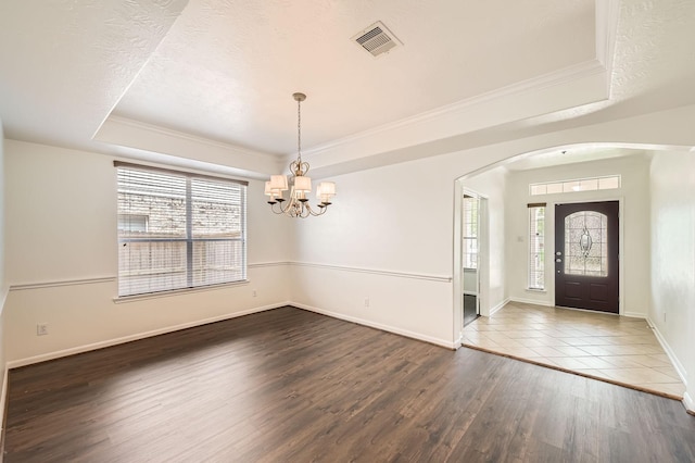 27122 Sable Oaks Ln, Cypress, TX 77433 - entryway with visible vents, arched walkways, a tray ceiling, and a healthy amount of sunlight