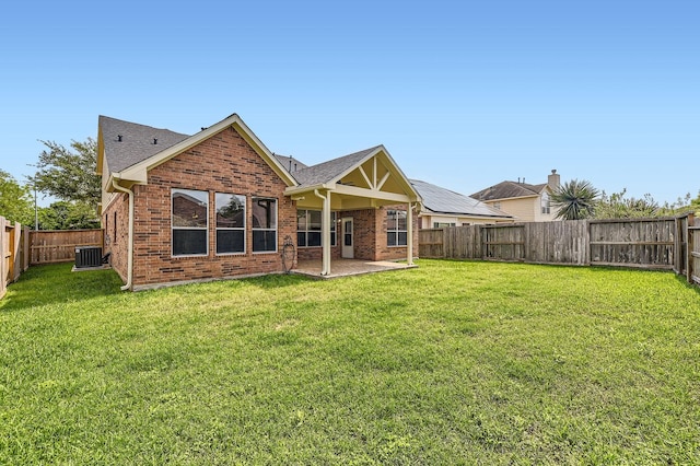 back of house featuring a patio, brick siding, central AC unit, and a fenced backyard