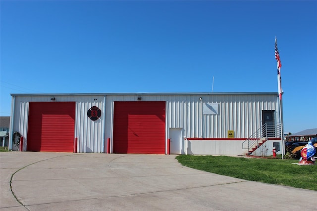 4006 Reeves Dr, Galveston, TX 77554 - view of front of home with a detached garage, an outbuilding, board and batten siding, and a front lawn