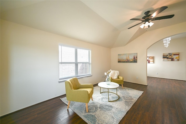 living area featuring wood finished floors, ceiling fan, vaulted ceiling, and arched walkways