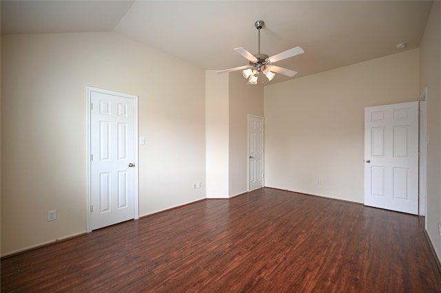 spare room with ceiling fan, lofted ceiling, and dark wood finished floors