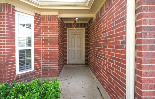 property entrance featuring brick siding