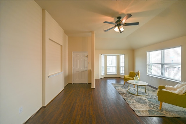 living room with baseboards, wood finished floors, a ceiling fan, and lofted ceiling