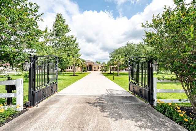 view of gate with a yard