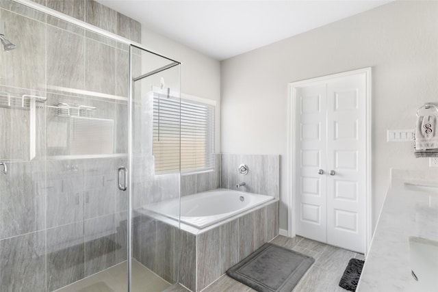 full bath with a shower stall and a garden tub