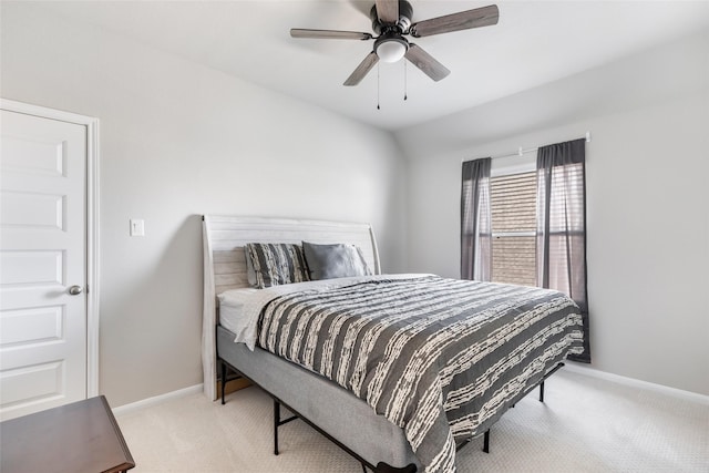 bedroom with a ceiling fan, light colored carpet, and baseboards