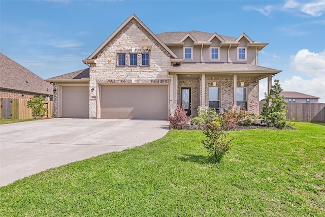 view of front facade with a front yard, stucco siding, concrete driveway, an attached garage, and fence