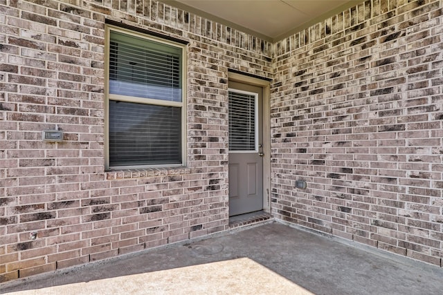 property entrance featuring brick siding
