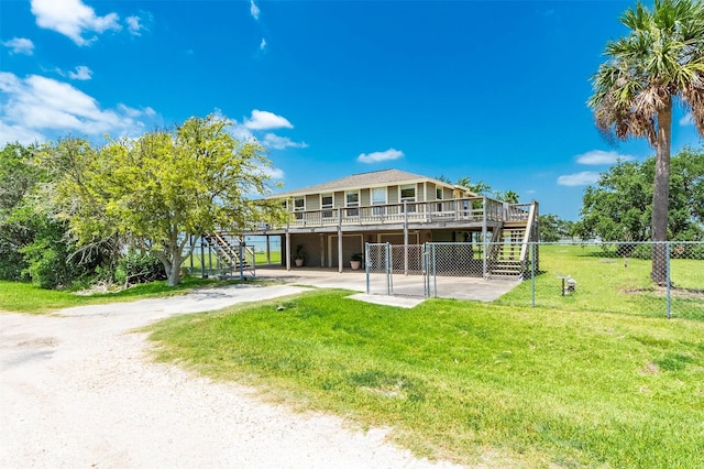 1102 15th St, San Leon, TX 77539 - back of house with a lawn, a wooden deck, stairway, and fence