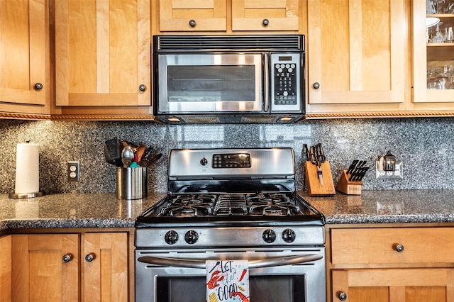 1102 15th St, San Leon, TX 77539 - kitchen featuring appliances with stainless steel finishes, light brown cabinets, glass insert cabinets, and backsplash