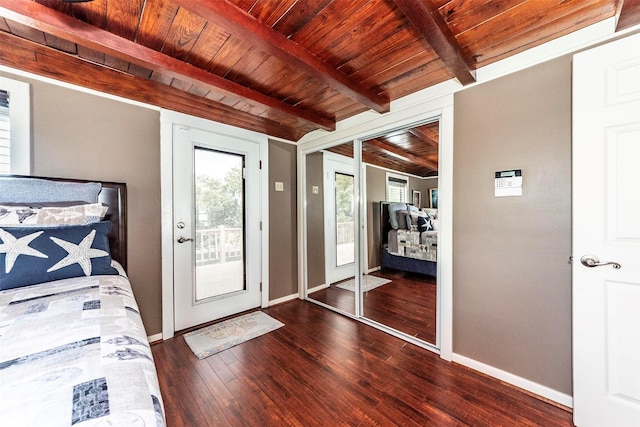 1102 15th St, San Leon, TX 77539 - unfurnished bedroom featuring baseboards, beam ceiling, wooden ceiling, wood finished floors, and access to outside