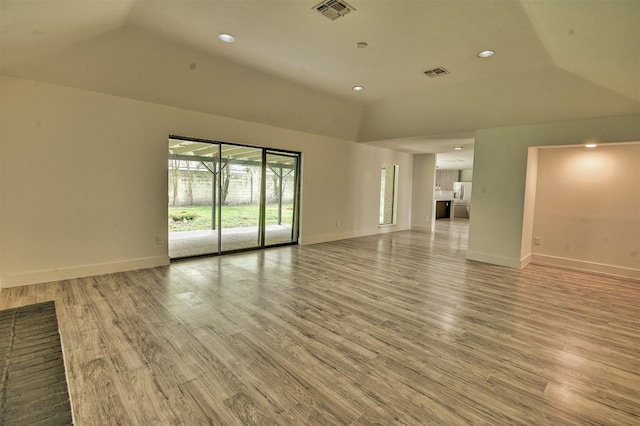 15626 Whitewater Ln, Houston, TX 77079 - unfurnished living room featuring baseboards, lofted ceiling, light wood-style flooring, and visible vents