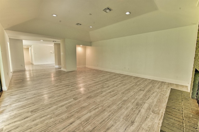 15626 Whitewater Ln, Houston, TX 77079 - unfurnished living room with visible vents, a fireplace, baseboards, light wood-style flooring, and vaulted ceiling