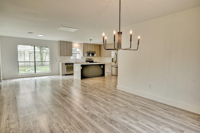 15626 Whitewater Ln, Houston, TX 77079 - kitchen featuring light countertops, a chandelier, a center island, stainless steel appliances, and open floor plan