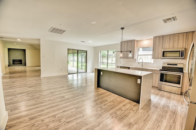15626 Whitewater Ln, Houston, TX 77079 - kitchen with visible vents, modern cabinets, a sink, open floor plan, and stainless steel appliances