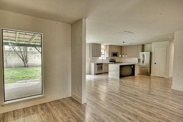 15626 Whitewater Ln, Houston, TX 77079 - kitchen featuring baseboards, light countertops, a kitchen island, and stainless steel appliances