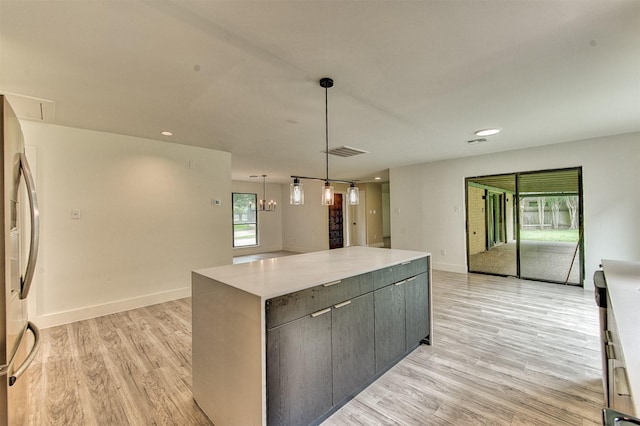 15626 Whitewater Ln, Houston, TX 77079 - kitchen with stainless steel refrigerator, light wood finished floors, a center island, open floor plan, and visible vents