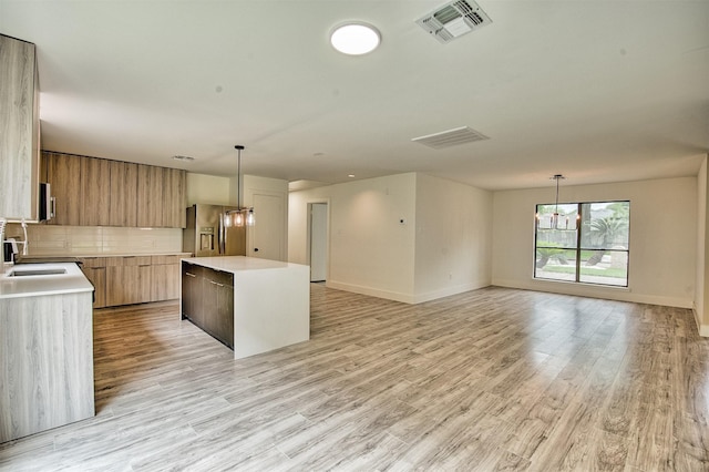 15626 Whitewater Ln, Houston, TX 77079 - kitchen with visible vents, modern cabinets, a center island, light countertops, and stainless steel appliances