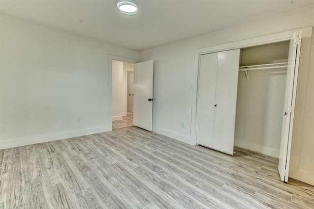 15626 Whitewater Ln, Houston, TX 77079 - unfurnished bedroom featuring baseboards, a closet, and wood finished floors