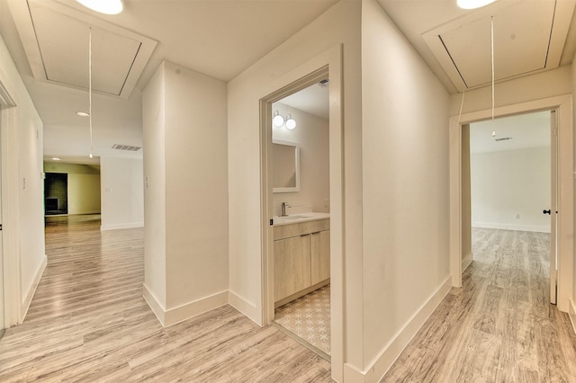 15626 Whitewater Ln, Houston, TX 77079 - hallway featuring attic access and light wood-style flooring
