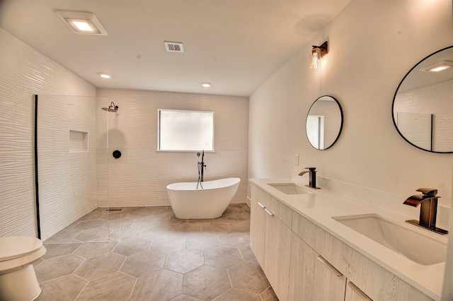 15626 Whitewater Ln, Houston, TX 77079 - bathroom featuring visible vents, a sink, tile patterned flooring, and a tile shower