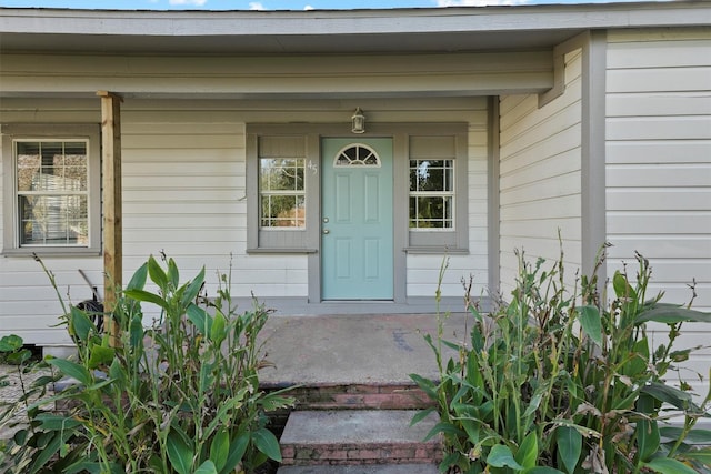 view of exterior entry with covered porch
