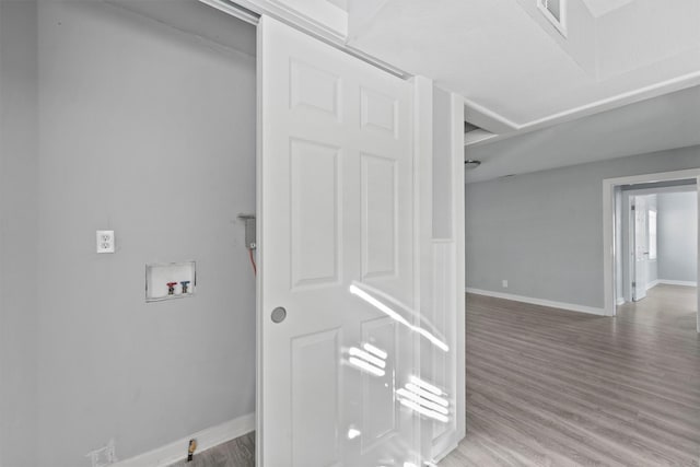interior space featuring wood finished floors and baseboards